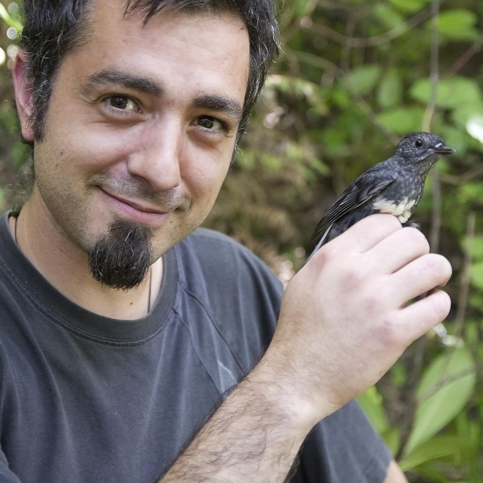Yvan Richard with a robin just after catching it - credit: Thomas Burns